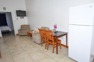 uma cozinha com uma mesa e cadeiras e um frigorífico em Lord Nelson Hotel & Residences 