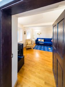 a living room with a blue couch and a table at Stairway to the castle in Ljubljana