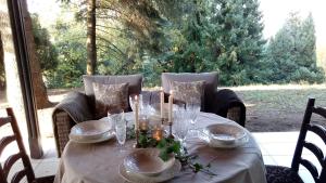 a table with plates and glasses on top of it at MilBor Fruška Gora in Novi Sad