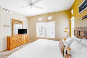 a bedroom with a bed and a flat screen tv at Vistoso Resort Casita #163A in Tortolita +26 photos