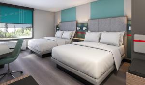 Tempat tidur dalam kamar di avid hotel - Fresnillo, an IHG Hotel