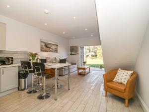 a kitchen and dining room with a table and chairs at Greenlawns in Burnham on Sea