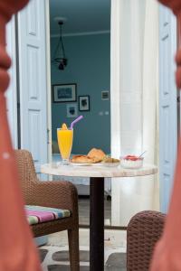 a table with a drink and some food on it at 7 Brothers Hotel in Poros +21 photos