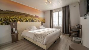 a bedroom with a bed with a painting on the wall at Best Western Hotel Ile de France in Château-Thierry