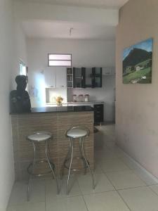 a kitchen with two stools at a kitchen counter at Morada do Sol in Valença +27 photos