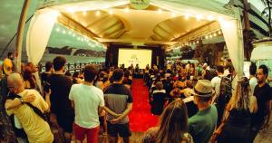 a crowd of people standing around in a tent at PontaNegra PontadoSolluciene 4B in Natal +22 photos