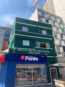 a hotel head raikkom raikkim with a building at Hotel Real Paulista in Sao Paulo