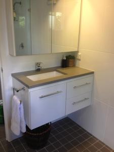 a bathroom with a sink and a mirror at Jacaranda House Garden Retreat in Brisbane