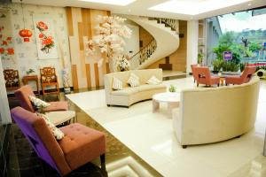a living room filled with furniture and decor at Harmoni Hotel Garut in Garut