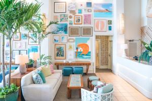 a living room with a couch and a table at Kaimana Beach Hotel in Honolulu