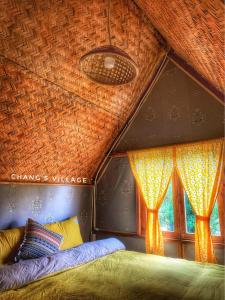 A bed or beds in a room at Chang's Village