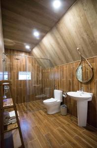 a bathroom with a toilet and a sink and a shower at TTC Dreamy Hill Resort - Unlimited Access to TTC World - Thung Lung Tinh Yeu in Da Lat +48 photos