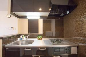 a kitchen with a sink and a stove at ようこそ札幌へ! 大通公園まで地下鉄10分 定員6名 fireTV完備 1階はセコマ in Sapporo