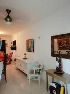a living room with a desk and a table at Posada Dilia del Alba in Santo Domingo