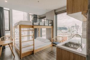 a small bedroom with a bunk bed and a sink at IKIGAI Dorm Hostel - Danang Centre in Da Nang