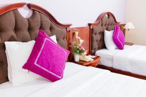 Postel nebo postele na pokoji v ubytování TTC Hotel - Da Lat