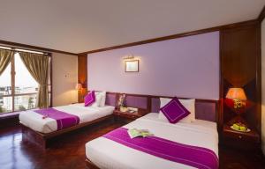 Postel nebo postele na pokoji v ubytování TTC Hotel - Da Lat
