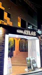a hotel entrance with a sign that reads hope atlas at HOTEL ATLAS Shinkabukicho (Adult Only) in Tokyo