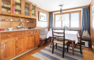 a kitchen with a table and a dining room at 1 Bedroom Awesome Home In Sankt Veit-defereggenta in Gassen