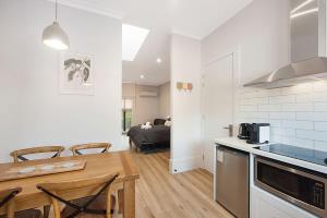 a kitchen and living room with a table and chairs at Little Hopwood Apartment No1 in Echuca