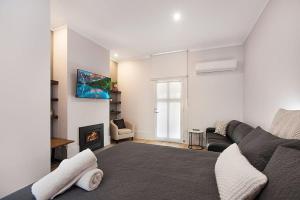 a living room with a couch and a fireplace at Little Hopwood Apartment No1 in Echuca