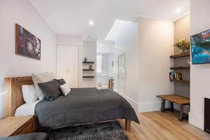a bedroom with a bed and a living room at Little Hopwood Apartment No1 in Echuca