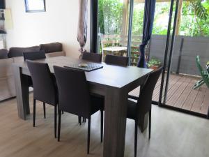 a dining room table and chairs in a living room at LE FRUIT A PAIN in Saint-Joseph