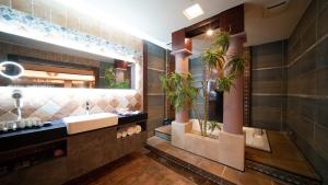 a bathroom with a sink and two potted plants at I-more Motel in Yonghe