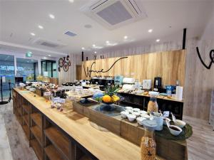 a kitchen with a counter with food on it at Green Rich Hotel Miyazaki Tachibandori 2 (Artificial hot spring Futamata Yunohana) in Miyazaki