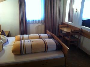 Postel nebo postele na pokoji v ubytování Hotel Garni Pfandl