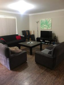 a living room with two couches and a coffee table at Surf Mist in Nowra