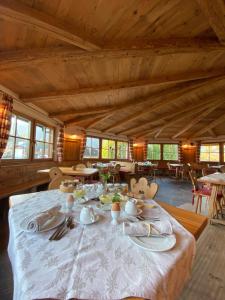 a dining room with a table in a wooden house at Agriturismo Maso Corradini in Castello di Fiemme