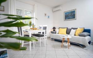 a living room with a couch and a table at Apartments Bogdanić in Stari Grad