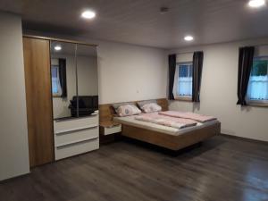a bedroom with a bed and a large mirror at Schoppenstube May in Weigenheim