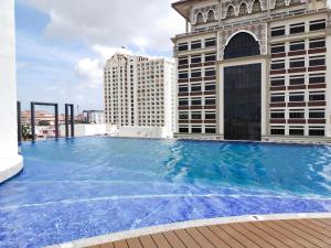 a large swimming pool on top of a building at CMK TROIKA APARTMEN#Free Netflix in Kota Bharu