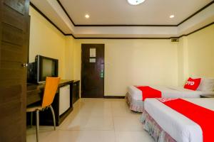 Ένα ή περισσότερα κρεβάτια σε δωμάτιο στο Super OYO 75385 Hotel Win Long