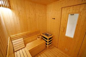 a wooden cabin with a sauna with a window at Pacific Park Hotel in Si Racha