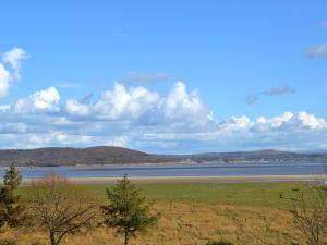 a view of a large body of water with mountains at Bay Villa in Grange Over Sands