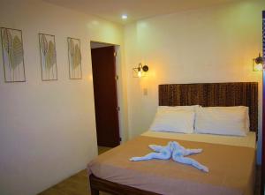 Postel nebo postele na pokoji v ubytování Thirdys Tourist Inn + 10 fotografií