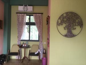 a dining room with a table and a window at Wuju Wusu B&B in Wenlan