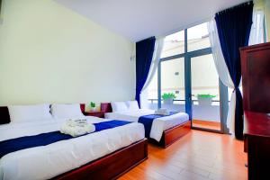 Postel nebo postele na pokoji v ubytování Bách Thảo Hotel