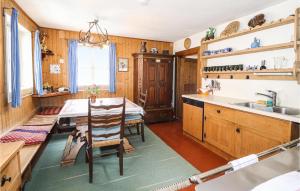 a kitchen with wooden cabinets and a table and a sink at Amazing Home In Sankt Veit-defereggenta With 5 Bedrooms And Wifi in Gassen