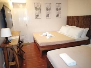 Postel nebo postele na pokoji v ubytování Thirdys Tourist Inn