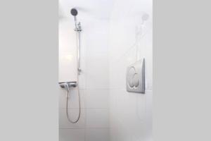 a shower with a shower head in a bathroom at BougainvillaStudio in Cesme