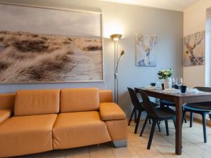 a living room with a couch and a table at VacationClub - Zielone Tarasy Apartament 51 in Kołobrzeg