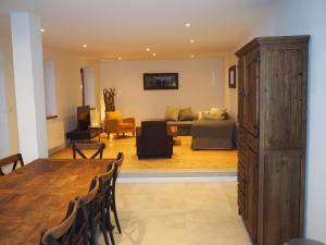 a living room with a table and chairs and a couch at LE MONT BLANC 160 in Saint-Gervais-les-Bains