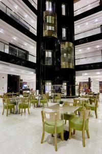a restaurant with tables and chairs in a building at Duset Hotel Suites in Riyadh