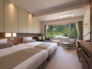 Postel nebo postele na pokoji v ubytování Kamikochi Hotel Shirakabaso