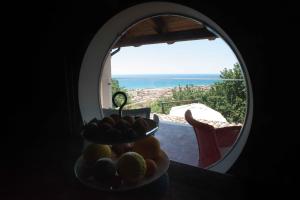 a bowl of fruit on a table in front of a window at Residenza Lombardi in Ascea