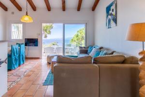 a living room with a couch and a view of the ocean at La villa Acacia in Coti-Chiavari